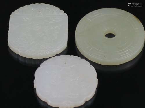 Three Chinese Carved White and Celadon Jade Amulets