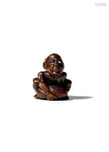 A JAPANESE WOOD AND IVORY NETSUKE