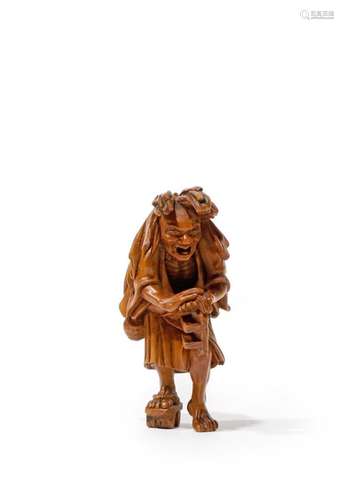 A TALL JAPANESE WOOD NETSUKE