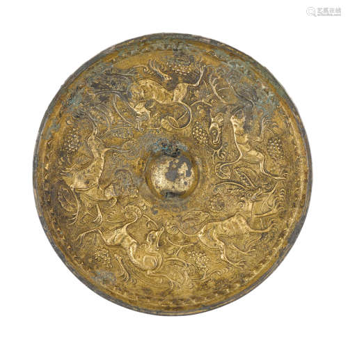 PARCEL-GILT BRONZE 'LION AND GRAPEVINE' MIRROR SUI/TANG DYNASTY