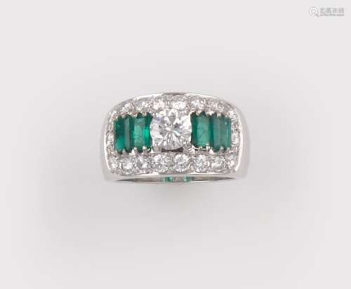 A diamond and emerald ring