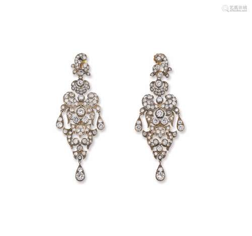 A pair of diamond, gold and silver chandelier earrings. Fitted case