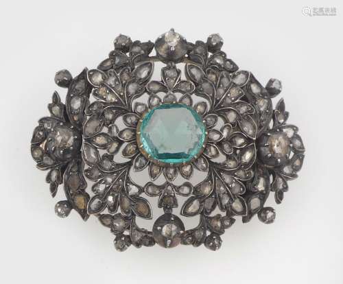 An emerald and silver brooch