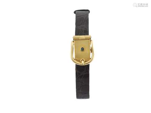 HERMES, Paris, No. 49341, 18K yellow gold lady's wristwatch with concealed dial and case  in the shape of a belt and  and 18K yellow gold buckle. Made circa 1950