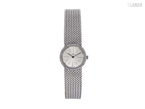 MOVADO, 18K lady's wristwatch with diamonds and an 18K white gold bracelet.  Made circa 1960