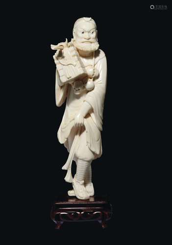 A carved ivory figure of wayfarer with skulls necklace, China, early 20th century