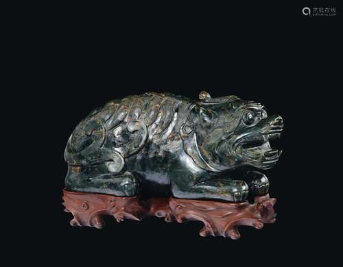 A large carved spinach green and russet jade Pho dog, China, Ming Dynasty, 17th century