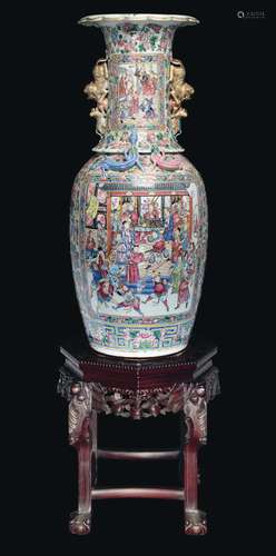 A large polychrome enamelled porcelain vase depicting court life scenes within reserves on a wooden stand with marble top, China, Canton, Qing Dynasty, 19th century