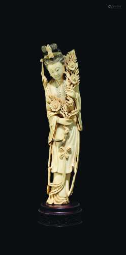 A carved ivory figure of Guanyin with flowers, China, early 20th century