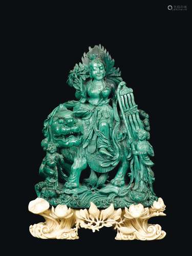 A finely carved malachite group with Guanyin on a Pho dog and children with carved ivory stand, China, Qing Dynasty, late 19th century