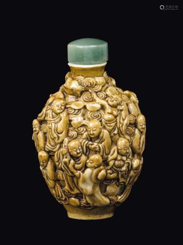 A porcelain snuff bottle with figures in relief, China, Qing Dynasty, 19th century