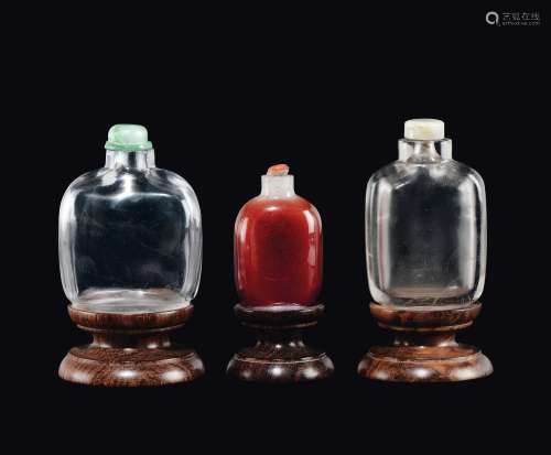 Three snuff bottles, two crystal rock' and a red glass one, China, Qing Dynasty, 19th century