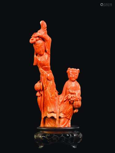 A carved coral group of Guanyin and child with basket of flowers, China, early 20th century
