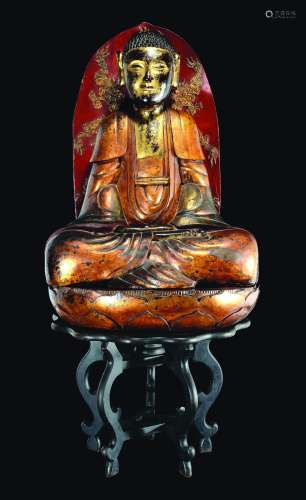 A large carved gilt and lacquered wood figure of Buddha with aura on a lotus flower, Southern China, Qing Dynasty, 19th century