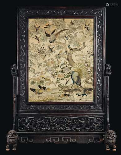 A carved wood firescreen with a silk cloth embroidered with birds, peacocks and roses, China, Qing Dynasty, 19th century