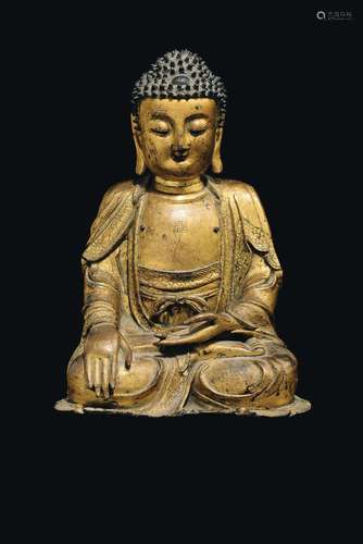 A gilt bronze figure of Buddha with swastika, China, Ming Dynasty, 16th century