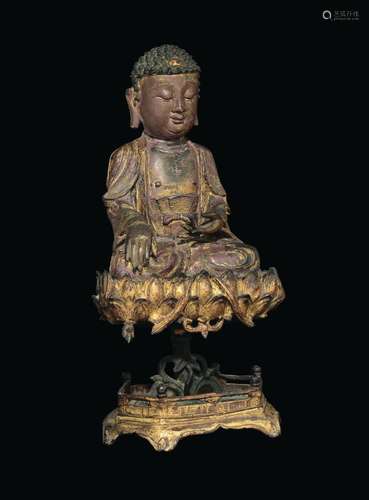 A large semi-gilt bronze figure of Buddha seated on a lotus flower stand, China, Ming Dynasty, 17th century