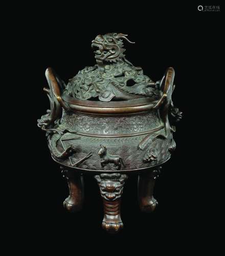A bronze tripod censer and cover with dragons and animals in relief, China, Qing Dynasty, 19th century