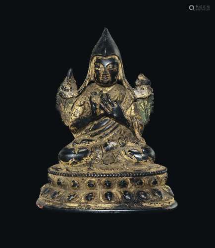 A gilt bronze figure of Tsong kha pa on a double lotus flower, Tibet, 17th century