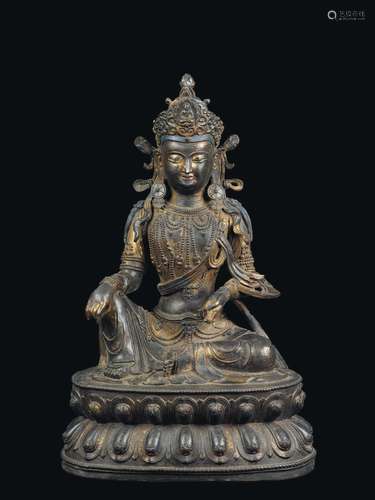 A large semi-gilt bronze figure of Avalokitesvara seated on a double lotus flower, China, Ming Dynasty, Yongle Period (1403-1424)