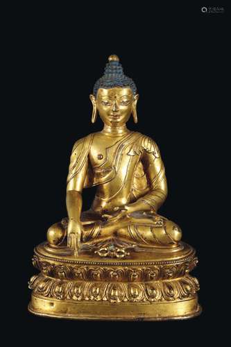 A gilt bronze figure of Sakyamuni Buddha with vajra on a double lotus flower, Tibet, 16th century