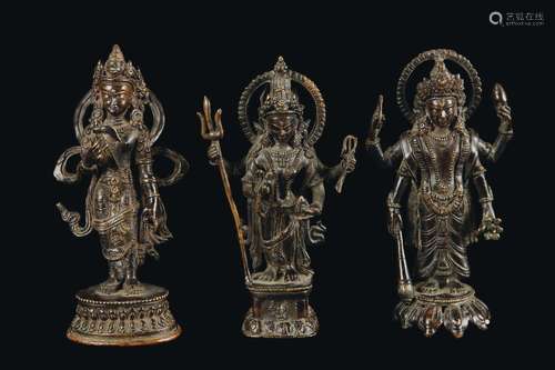 Three bronze standing deities with aura, Nepal, 18th century