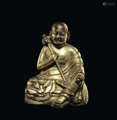 A gilt bronze figure of a monk, Tibet, 14th century