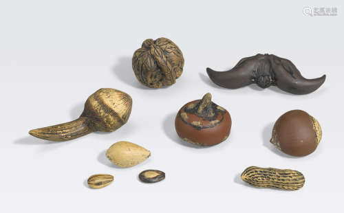 A group of nine Yixing pottery fruit, nuts and seeds