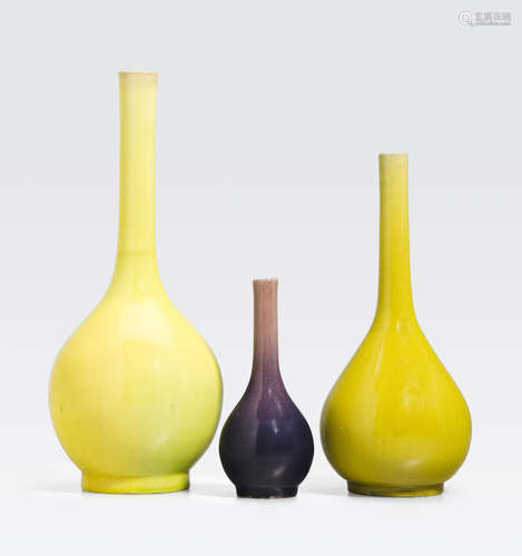 A group of three enameled stick neck vases