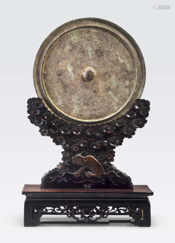 A large archaistic bronze mirror on wood stand Qing dynasty