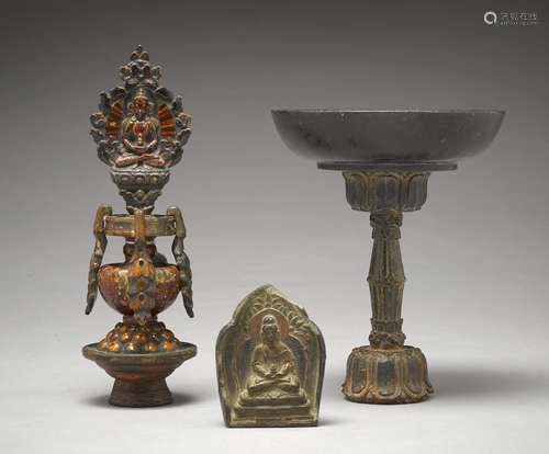 A clay tsa-tsa and two wood altar items Tibet, 18th/19th century