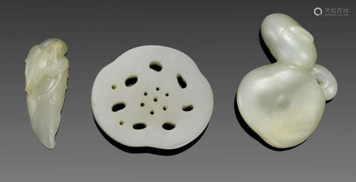 A group of three small white jade carvings