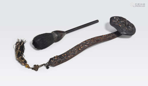 A carved wood ruyi scepter and a brush