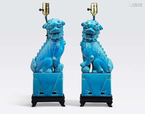 A pair of turquoise glazed porcelain fu-lions First half of the 20th century