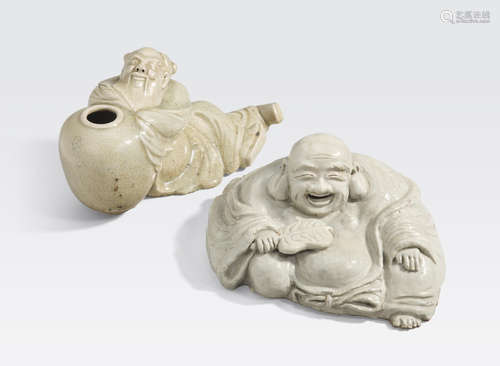 Two celadon glazed reclining figures