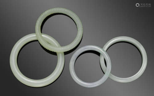 A group of four jade bangles