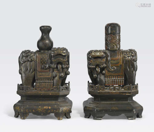 A pair of black and gilt lacquered wood lantern stands