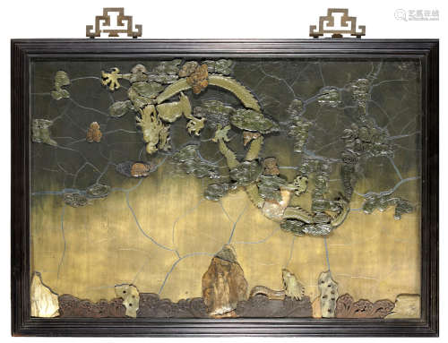 A lacquered wood wall plaque with jade and hardstone overlay decoration