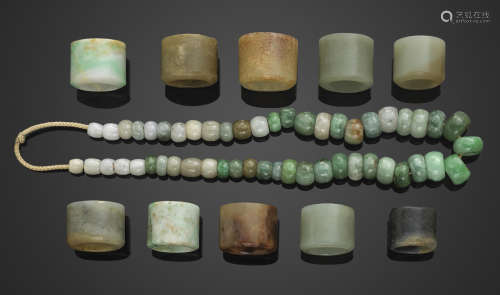 A group of ten jade and hardstone archer's rings and a string of assembled jadeite pieces