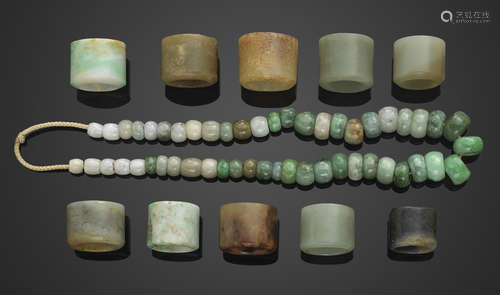 A group of ten jade and hardstone archer's rings and a string of assembled jadeite pieces