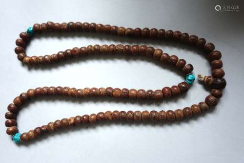 Rosaire Mala comprenant 108 perles en graines de pipal (arbre de la Bodhi ou ficus religiosa) en quatre groupes de 27 perles alternatant avec trois turquoises.