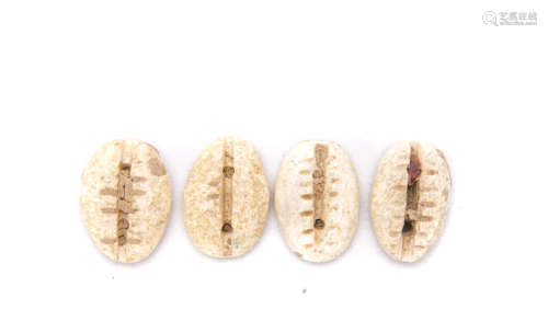 A Set Of Four 'Monetaria Moneta' Cowrie Shells