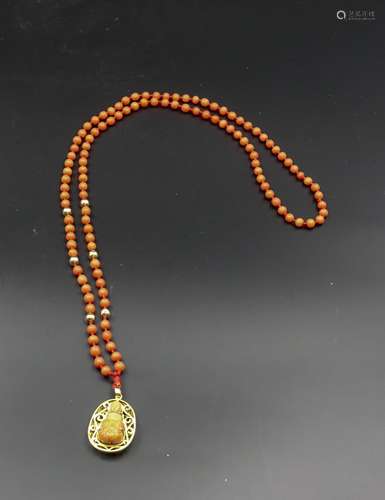 CHINESE CORAL BUDDHA AND GOLD PENDANT NECKLACE