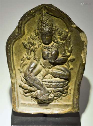 Pottery Plaque. Tibet or Nepal. 18th cent. Molded decoration of a seated figure of Tara. Traces of gilt remaining. Inscription at the back. 4