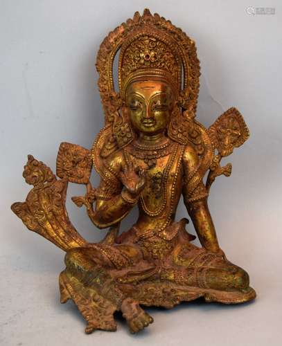 Gilt bronze Divinity. Nepal. 17th century. High copper content. Seated figure of Indra in royal apparel. 9-1/2