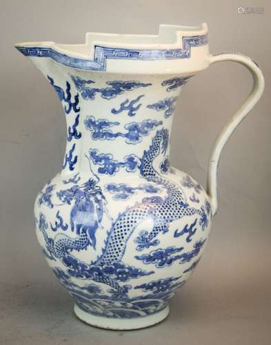 Porcelain ewer. China. 19th century. Monks hat form. Underglaze blue decoration of dragons and clouds flanking a celestial pearl. 12