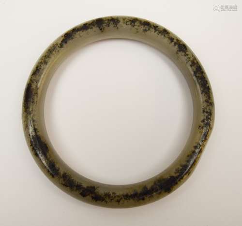 Jade bracelet. Grey stone with a single black marking to one side. 3