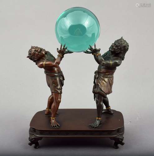 Mixed metal sculpture. Japan. Meiji period (1868-1912). Zani demons holding a glass sphere. Shakudo, copper and gold. (loss to one thumb). 9-1/2