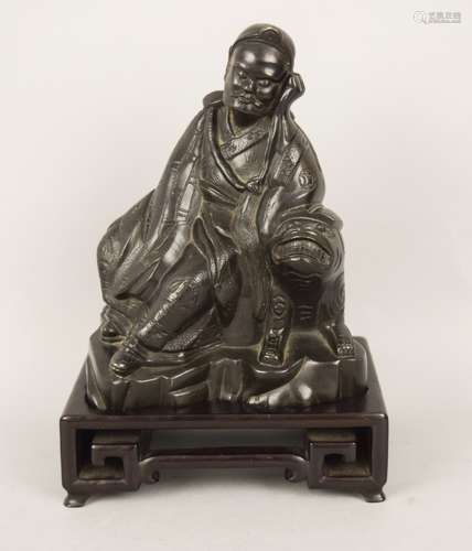 Bronze figure. China. 19th century. Seated figure of a sleeping Luohan with a tiger. 7-3/4