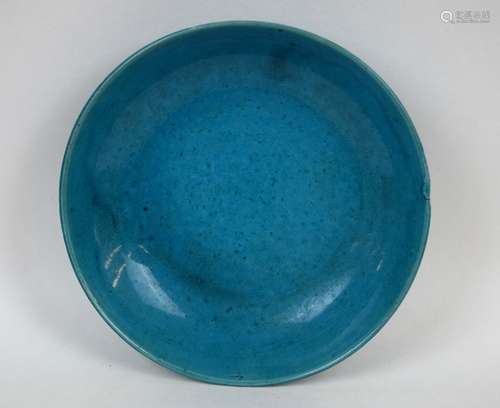 Porcelain saucer dish. China. 17th century. Turquoise glaze. Kiln flaw at the edge. 5-1/2